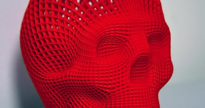 Skull printed with plastic of red color on a 3d printer
