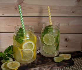 summer refreshing drink with lemon and lime in glasses