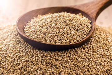 quinoa seeds in wooden spoon, seeds rich in calcium, iron and omega fatty acids