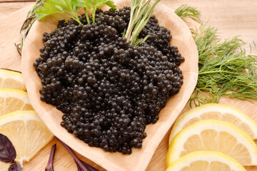 Black caviar with fresh herbs