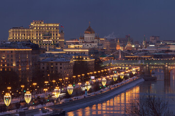 Fototapeta na wymiar Dark blue sunset with city lights and reflections in Moscow river. Travel concept.