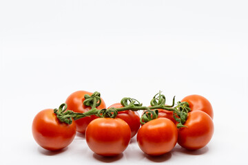 Fresh Tomatoes Isolated on White Background. Bunch of fresh, red tomatoes with green stems