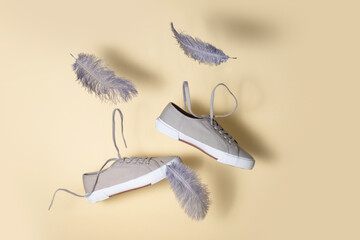 the concept of weightlessness and lightness. sneakers float in the air with flying feathers