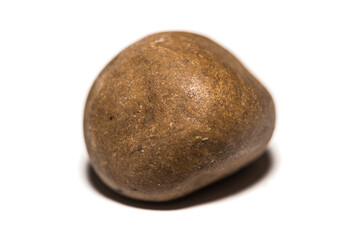 Close-up shot of pressed hash in front of a white background
