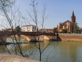 Panorama of the Church of "San Fermo Maggiore" seeing from the coast of the Adige river and "Ponte delle Navi" in the ancient part of the city of Verona in Italy