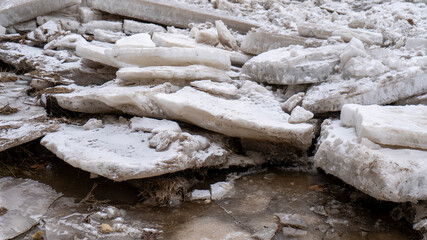 Huge Ice Loads Drift in the River Ogre, Latvia. Congestion on the River in the Spring. A Large Cluster of Moving Ice Blocks