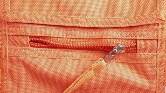 Close zipper of orange bag