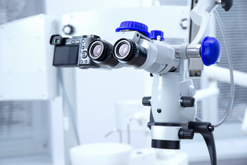 Professional Dental endodontic binocular microscope. Modern digital medicine equipment. Microscope for better treatment of oral problems.