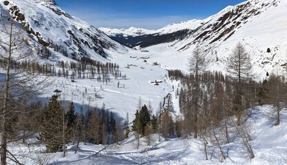 Picture towards mountain village sertig in the side valley of davos. Snow mountains with a river and beautiful trees