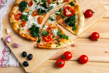 Pizza baked with with spinach and mozzarella.