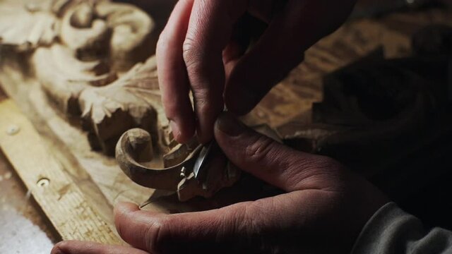 Close up of carver working with wood frame slow motion