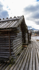 Araisi Lake Castle in Latvia. Historical Wooden Buildings on Small lake Island in the Frozen Lake Araisi in the Winter. Reconstruction of Wooden Fortified Settlement of Ancient European People