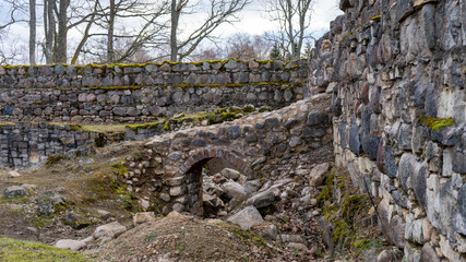 Fototapeta na wymiar Araishi (Araisi) Stone Walls Medieval Castle Ruins in Latvia, Gauja National Park. Castle Was Built in the 14th - 17th Century.