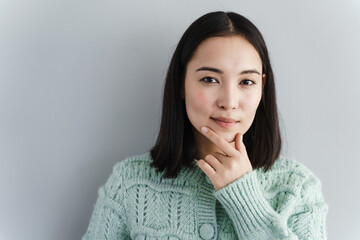 Portrait happy beautiful woman thinking looking up isolated grey wall background with copy space....