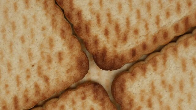 Close Up Top View Of Shortbread Cookies From The Store Rotate On A White Plate On A Kitchen Background. Baking And Bakery Concept. Selling Dessert In The Trade.