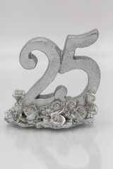 25th anniversary decoration for the silver wedding celebration with silver number in front of white...