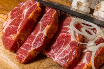 Raw neck of pork on a cutting board. Sliced raw meat. Preparing meat for the grill. Home food.
