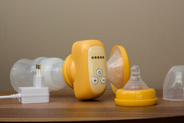 breast pump yellow on a wooden table