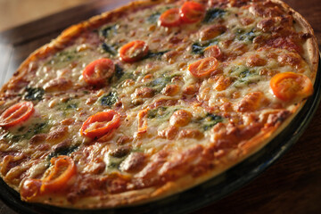 Close-up Oven-baked Golden Margherita Pizza with Mozzarella, Tomato and Basil on Plate