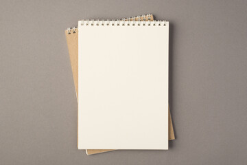 Above photo of two empty notebooks isolated on the grey background