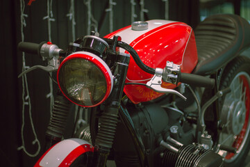 Red classic style motorcycle with black frame and steering wheel