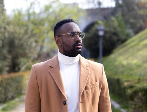 Portrait Of A African American Man With Glasses, Well Dressed. No Looking. In A Park