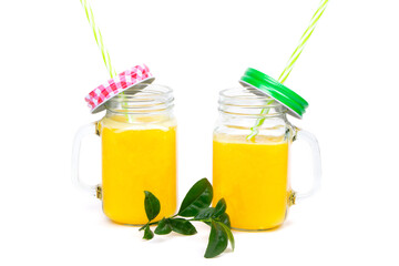 Orange juice and green leaves isolated on a white background.Two glasses of orange juice and drinking straw. Healthy food.