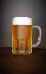 beer chopp on a brown leather-like surface and a black background