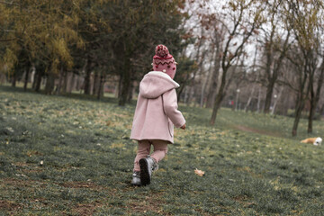 Baby girl walking in the park 