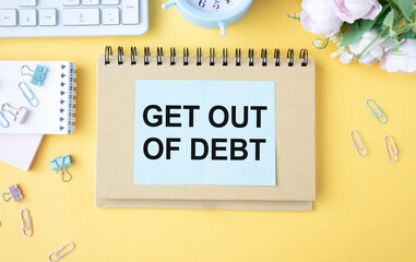 Paper note with text Get Out Of Debt