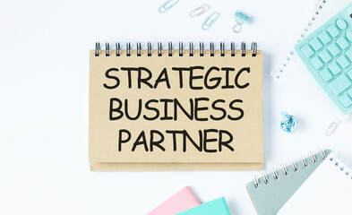 STRATEGIC BUSINESS PARTNER, pencils and glasses next to them.