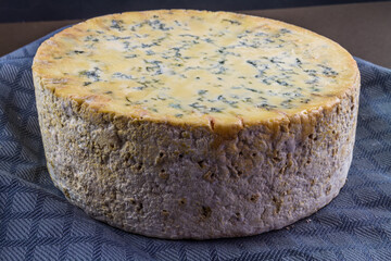 Large, massive truckle of stilton cheese.