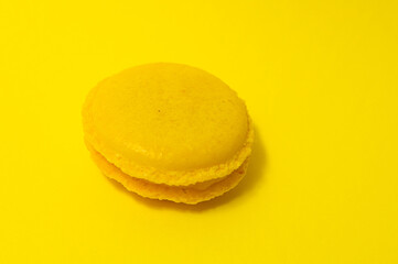 Yellow macaroons on yellow background