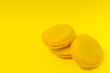 Yellow macaroons on yellow background