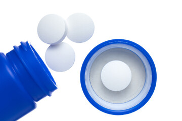 A blue bottle with medicine. Round white Pills on a white background.