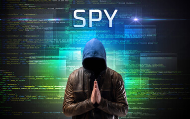 Faceless hacker on code background