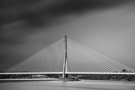 Fototapeta suspension bridge from the Waterford Highway to Kilkeny. Ireland. long exposure with cloudy day.