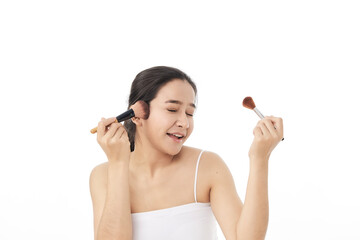 woman applying make up with a brush