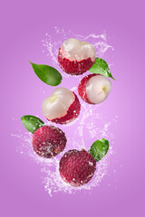 Water Splashing on Fresh lychee or litchi with over pink background