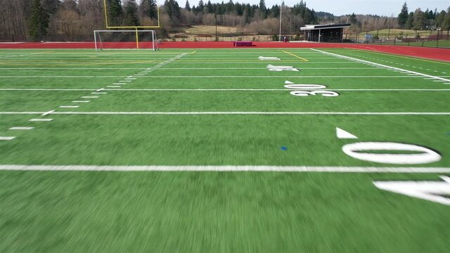 Zooming down the length of a football field toward the end zone for a touchdown