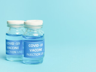 Selective focus COVID 19 VACCINE isolated on bluish background.  