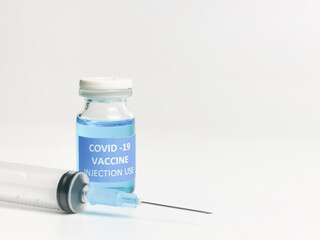 Selective focus close image of COVID 19 VACCINE with syringe isolated on white background.  
