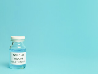 Selective focus COVID 19 VACCINE isolated on bluish background.  