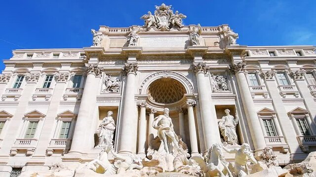 Slow Motion Panning Historic Downtown City Street By Trevi Water Fountain And Sculpture Building, Ancient Baroque Architecture Of Palazzo Palace Polio In Rome, Italy