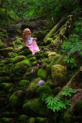 Red head woman in green forest. Mossy rocks and ferns in Silver Falls Park. Portland. Oregon. USA 