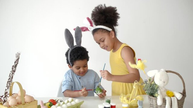 playing and coloring eggs for ester