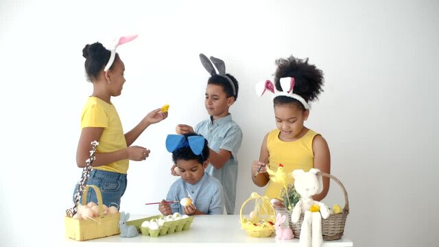 children having fun and coloring ester eggs