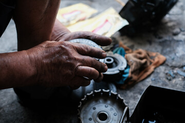 Motorcycle mechanics are assembling the motorcycle engine clutch assembly and maintenance.