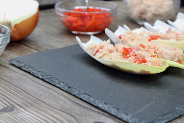 Endives dish filled with tuna, red pepper and onion 