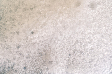 The texture of soap foam with small bubbles.